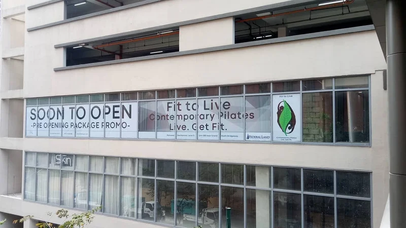 Pre-opening window signage installed on a building facade